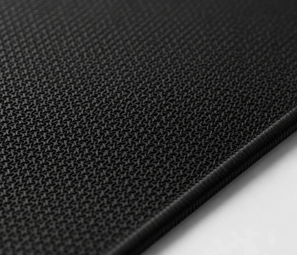 Black textured gaming mousepad with precision weave and stitched edge for smooth mouse control